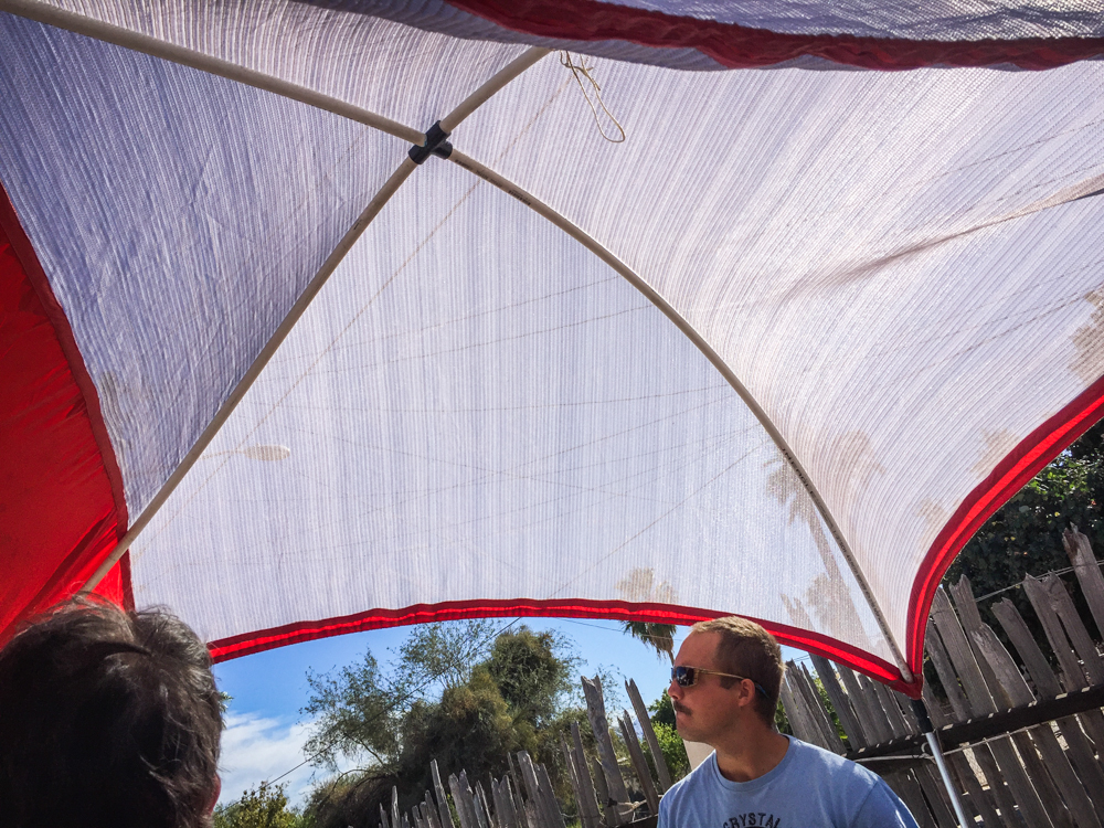 Admiring a homemade sun shelter awning on a fellow traveler's rig.