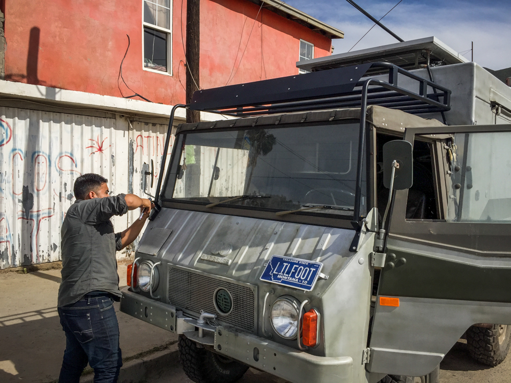 Installing Little Foot's new hat. It attaches in three places…on the machine gun mount, and on the hood where there were already bolts for the windshield to fold down.