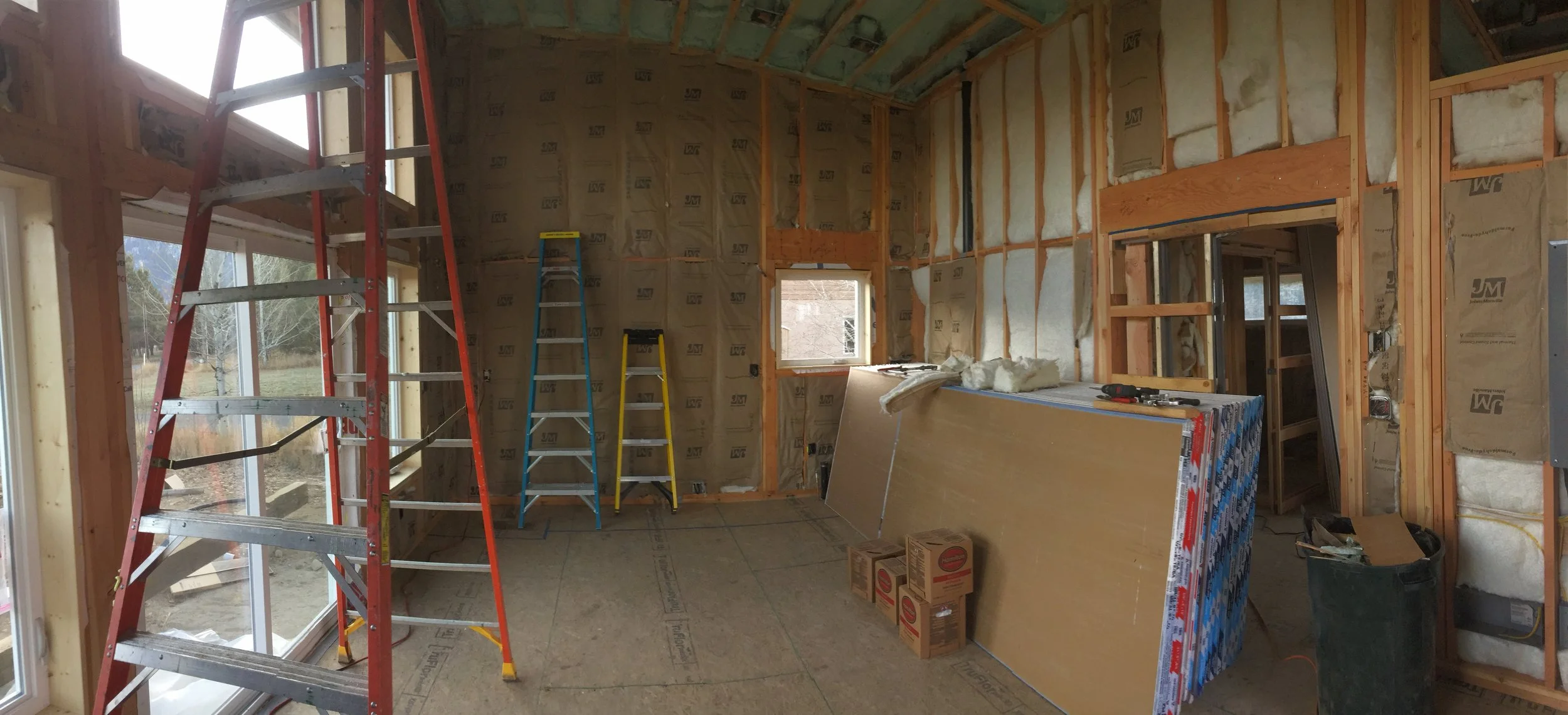 The interior, with insulation shortly before we had a team come put in drywall (we were going to do it ourselves, but were warned against how labor intensive it would be and how much time it would take with just the two of us. We’re so happy we hired someone else to do it for us.