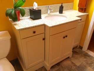 This custom vanity allows for storage without overwhelming the narrow room. 
