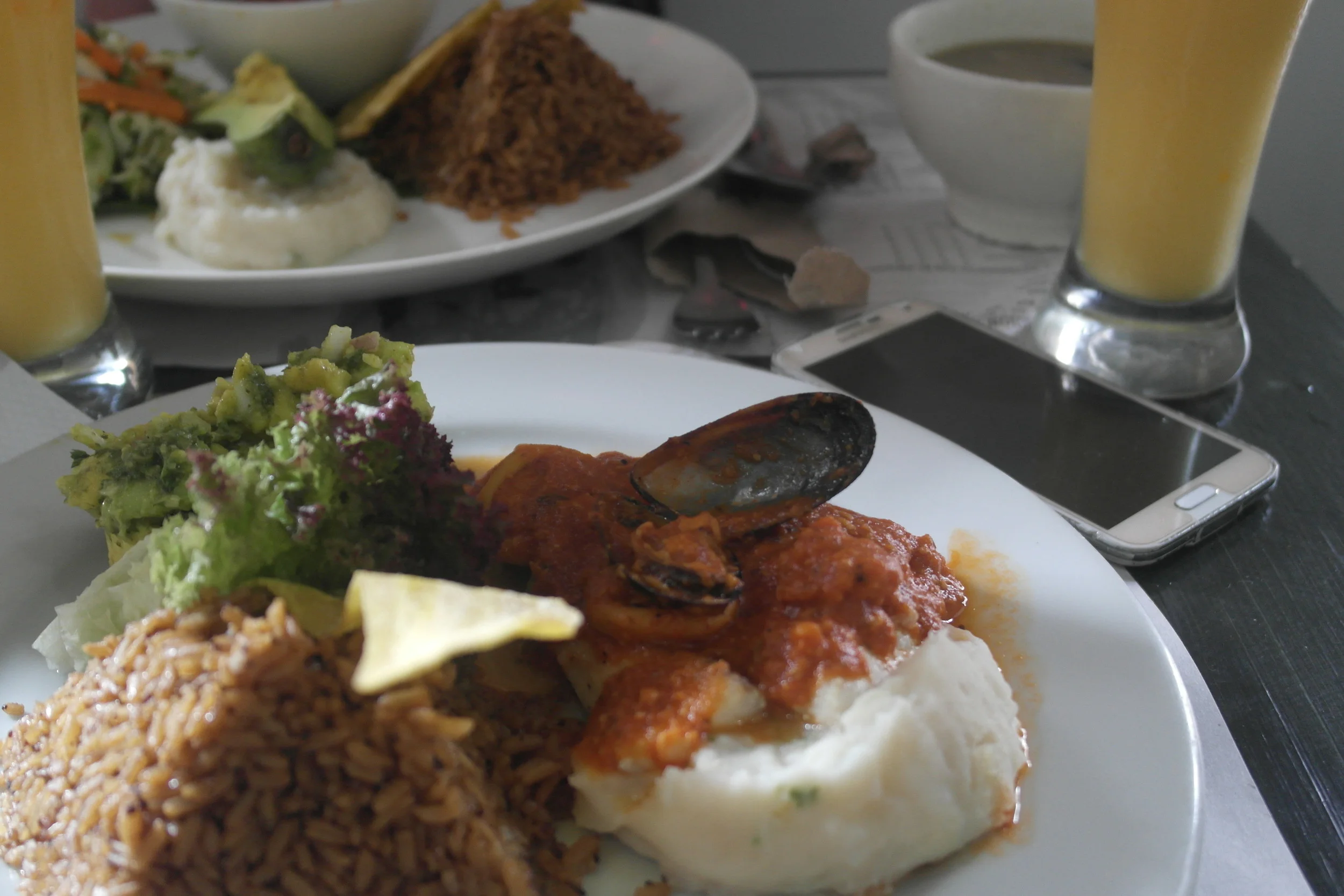 Fish, coconut rice, avocados, potatoes, yuca chip, and drink at La Mulata