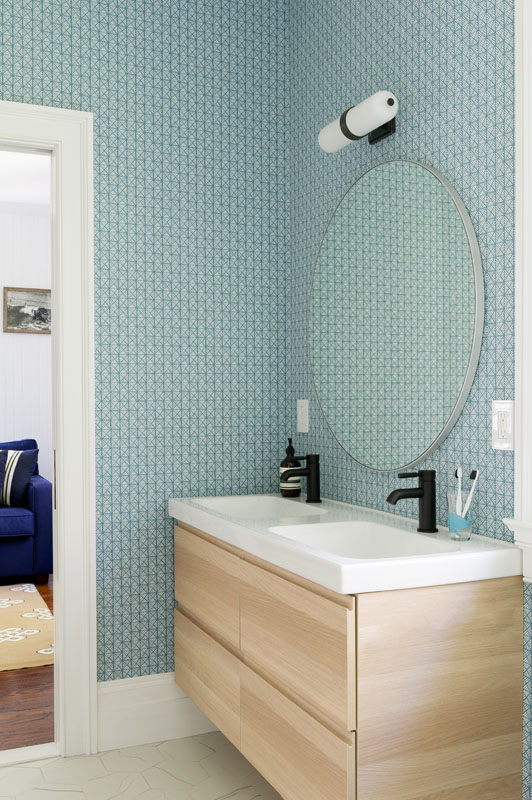The children’s Jack-and-Jill bathroom features geometric Serena and Lily wallpaper that turns a shared space into a charismatic extension of the connected bedrooms.