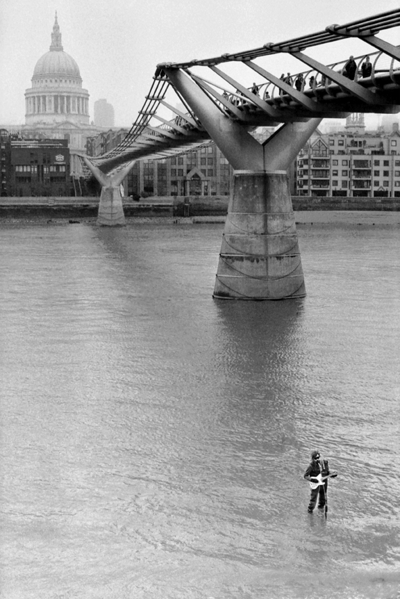 Street performer in the River Thames under the Millennium Bridge, London, England. 2012