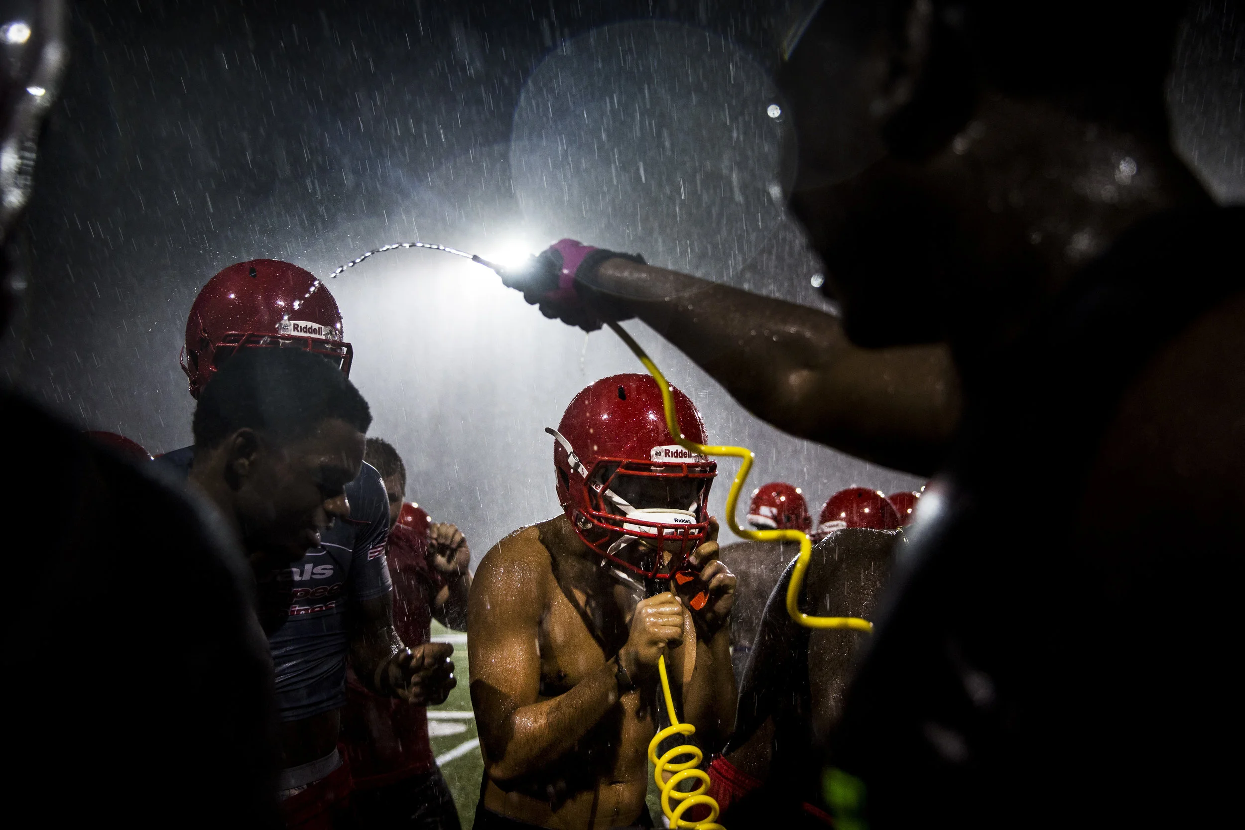  Immokalee varsity football players grab a drink during the first practice of the season at Immokalee High School on Monday, July 31, 2017.&nbsp; 