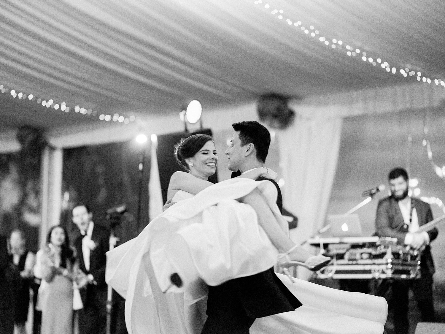 Bride and groom surrounded by family and friends during the reception