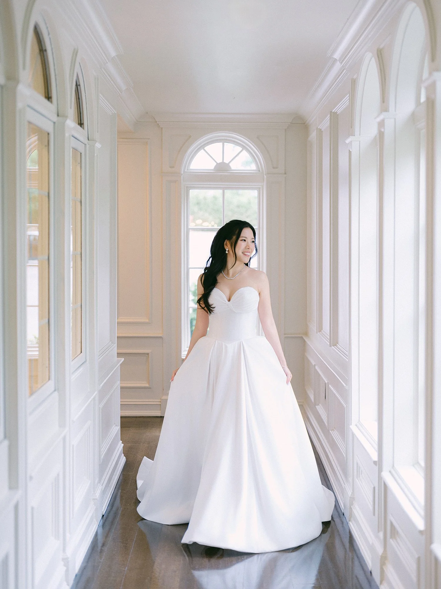  A bright and airy wedding portrait of Joann and Thomas sharing a romantic moment inside the elegant Nanina's in the Park venue. 