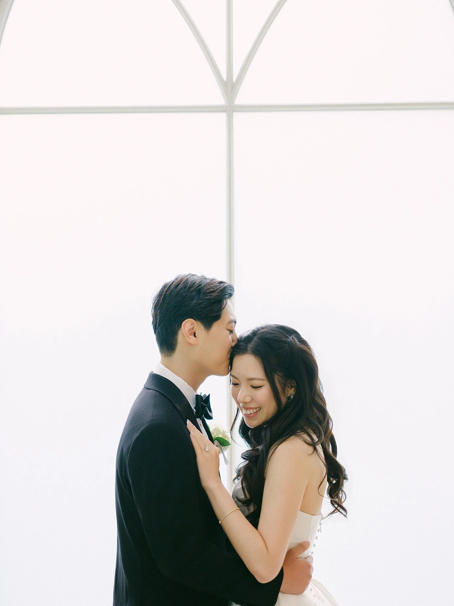  A bright and airy wedding portrait of Joann and Thomas sharing a romantic moment inside the elegant Nanina's in the Park venue. 