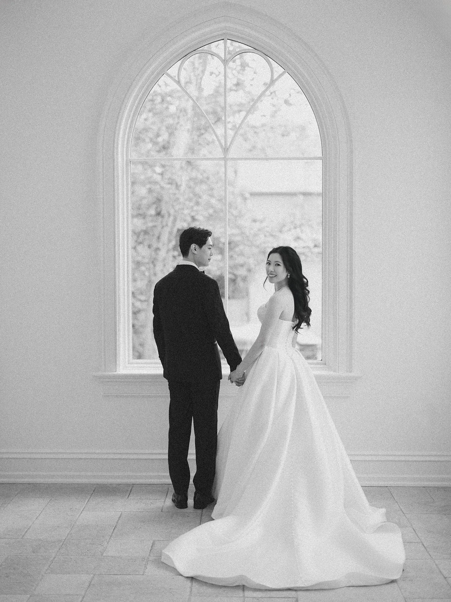  A bright and airy wedding portrait of Joann and Thomas sharing a romantic moment inside the elegant Nanina's in the Park venue. 