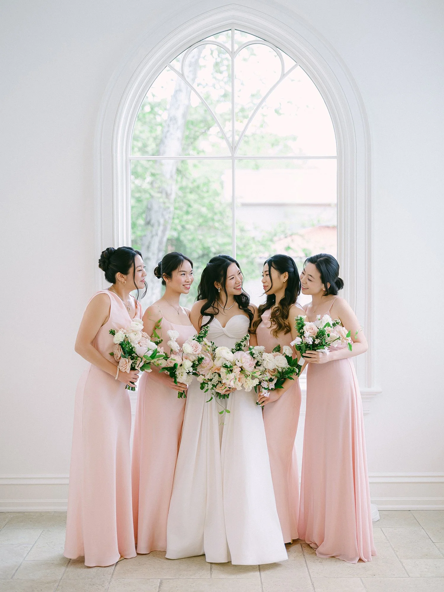 A bright and airy wedding portrait of Joann and Thomas sharing a romantic moment inside the elegant Nanina's in the Park venue. 