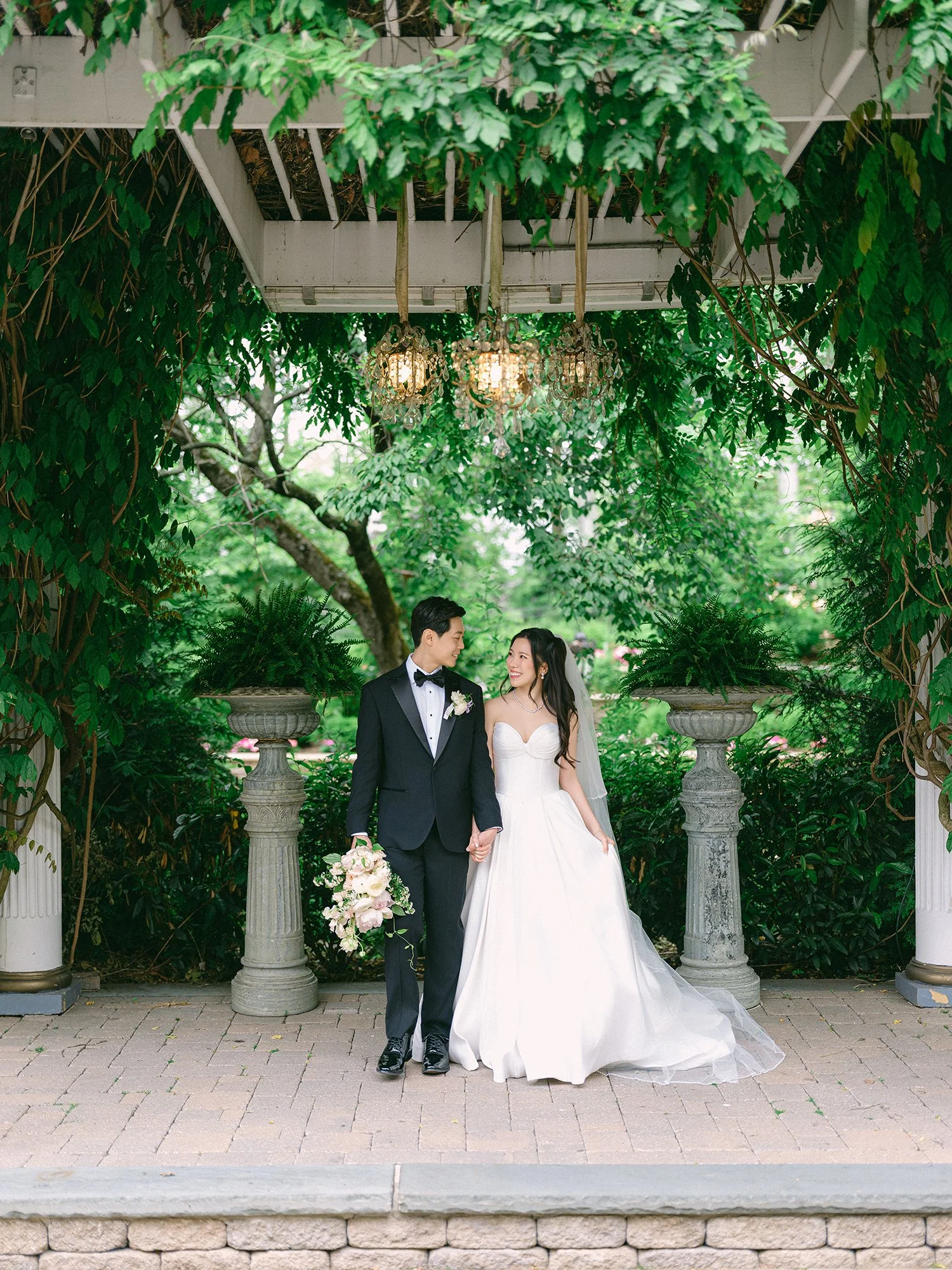  A bright and airy wedding portrait of Joann and Thomas sharing a romantic moment inside the elegant Nanina's in the Park venue. 