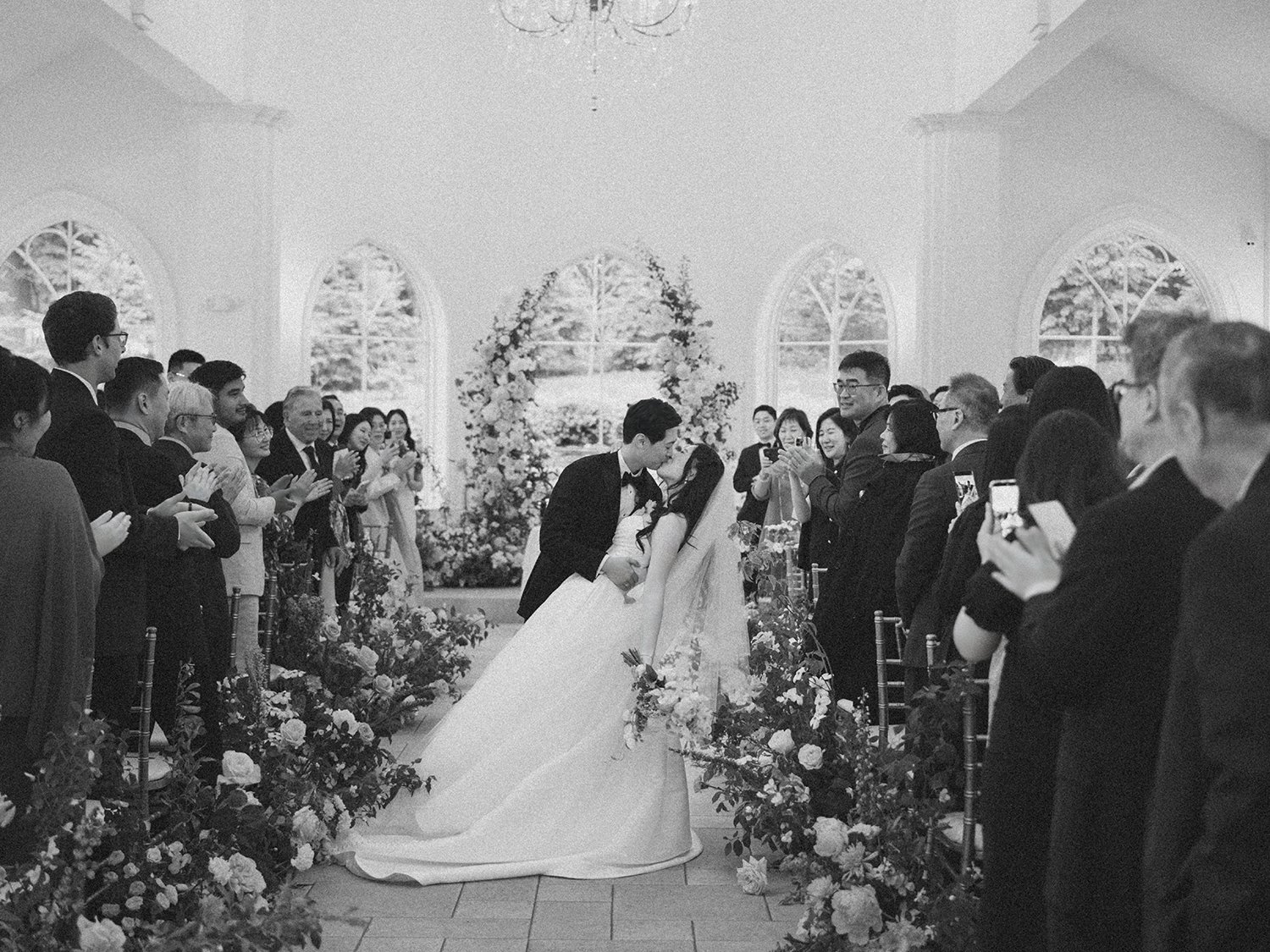  A bright and airy wedding portrait of Joann and Thomas sharing a romantic moment inside the elegant Nanina's in the Park venue. 