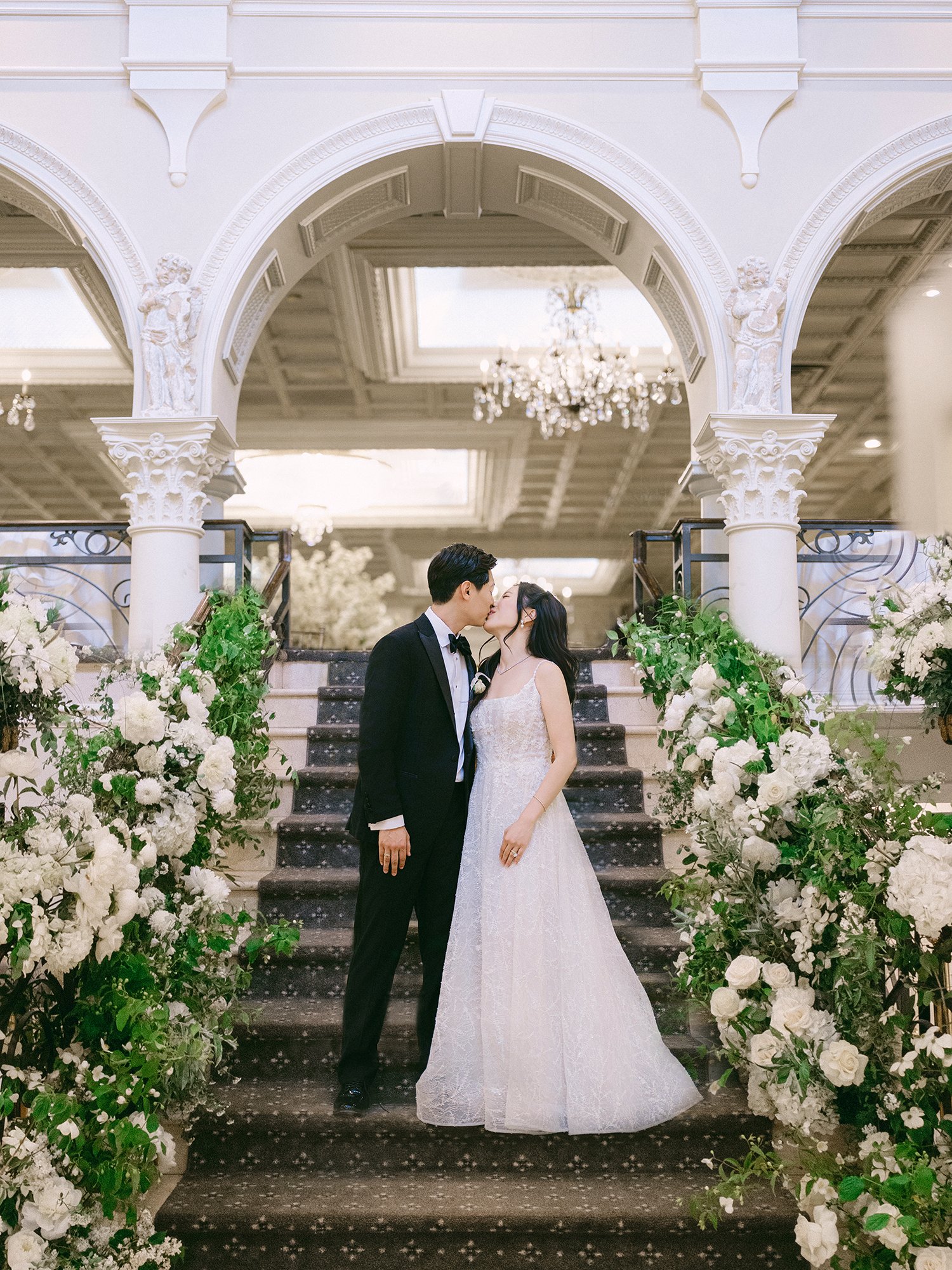 A bright and airy wedding portrait of Joann and Thomas sharing a romantic moment inside the elegant Nanina's in the Park venue. 
