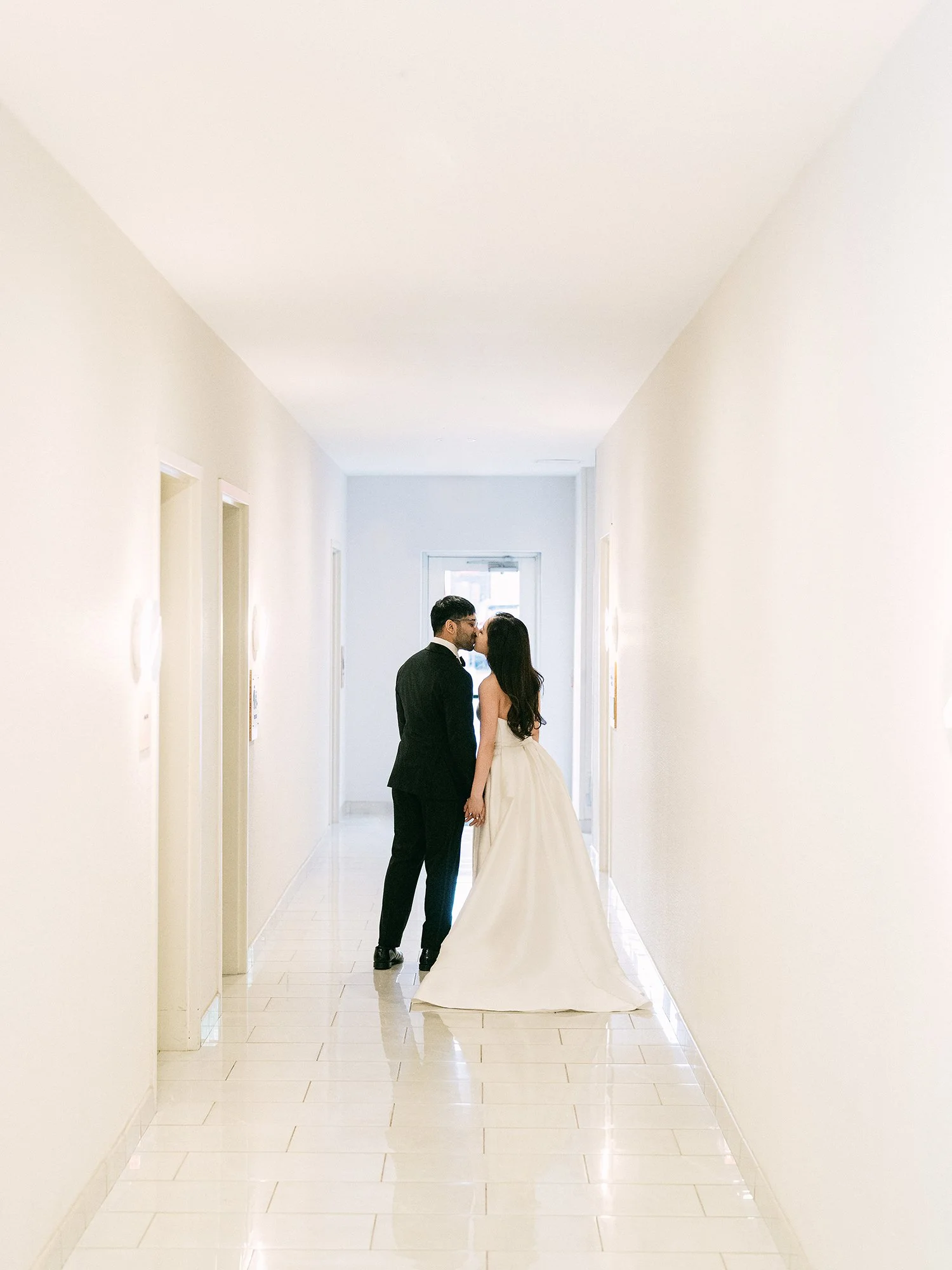  A grand and vibrant wedding portrait of Jenny and Shay sharing a joyful moment inside the luxurious ballroom of The Venetian in New Jersey. 