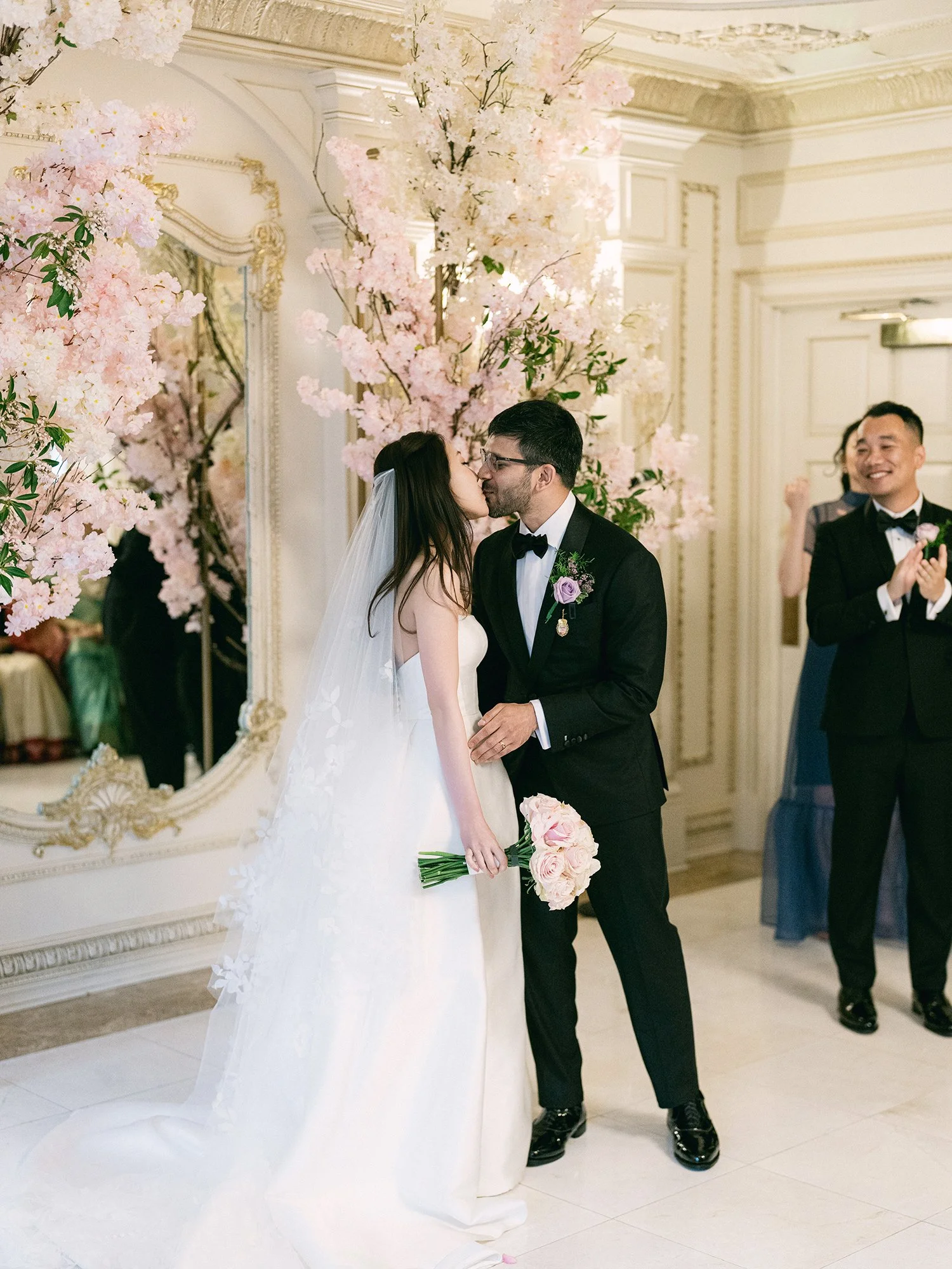  A grand and vibrant wedding portrait of Jenny and Shay sharing a joyful moment inside the luxurious ballroom of The Venetian in New Jersey. 