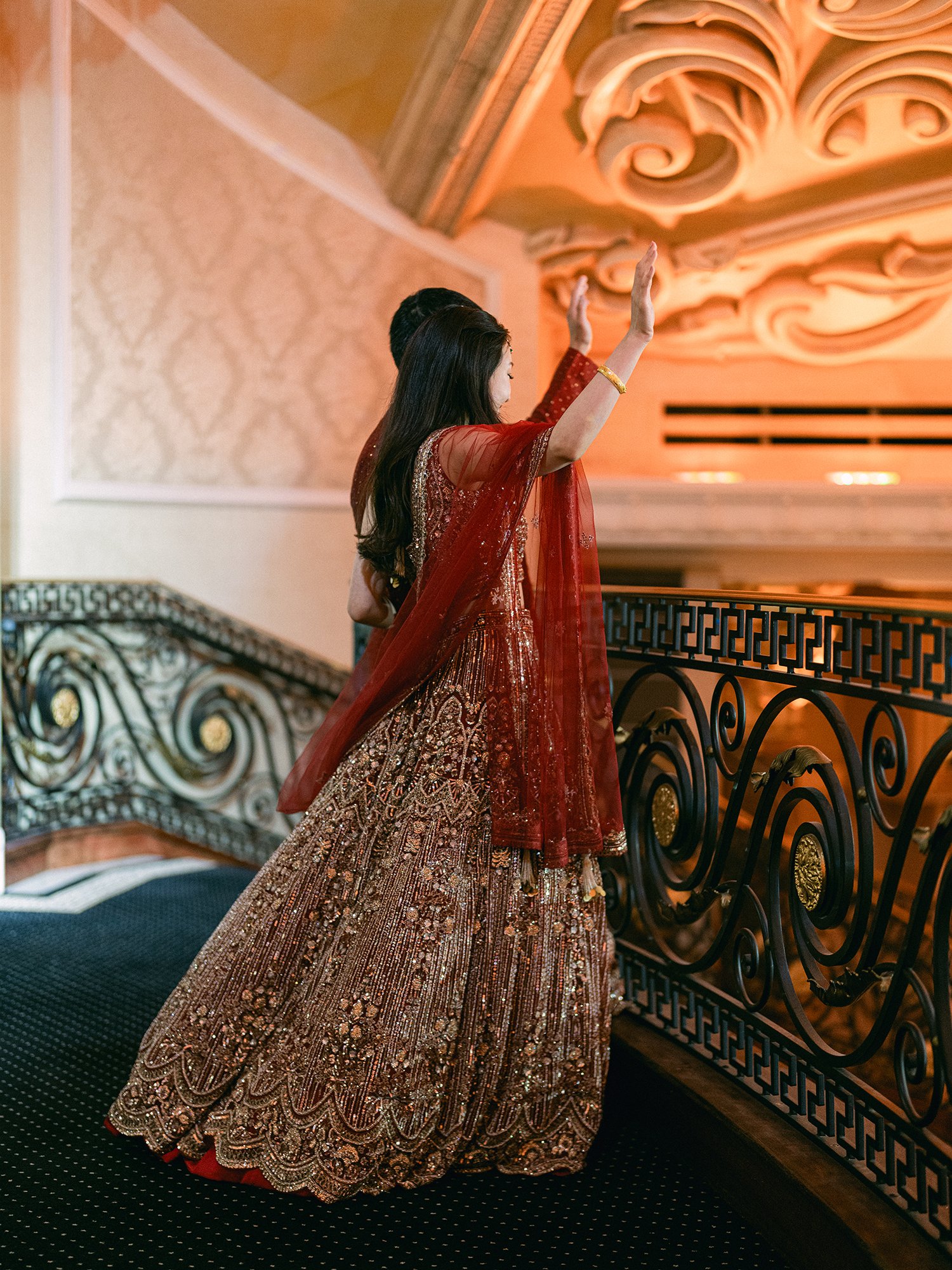  A grand and vibrant wedding portrait of Jenny and Shay sharing a joyful moment inside the luxurious ballroom of The Venetian in New Jersey. 