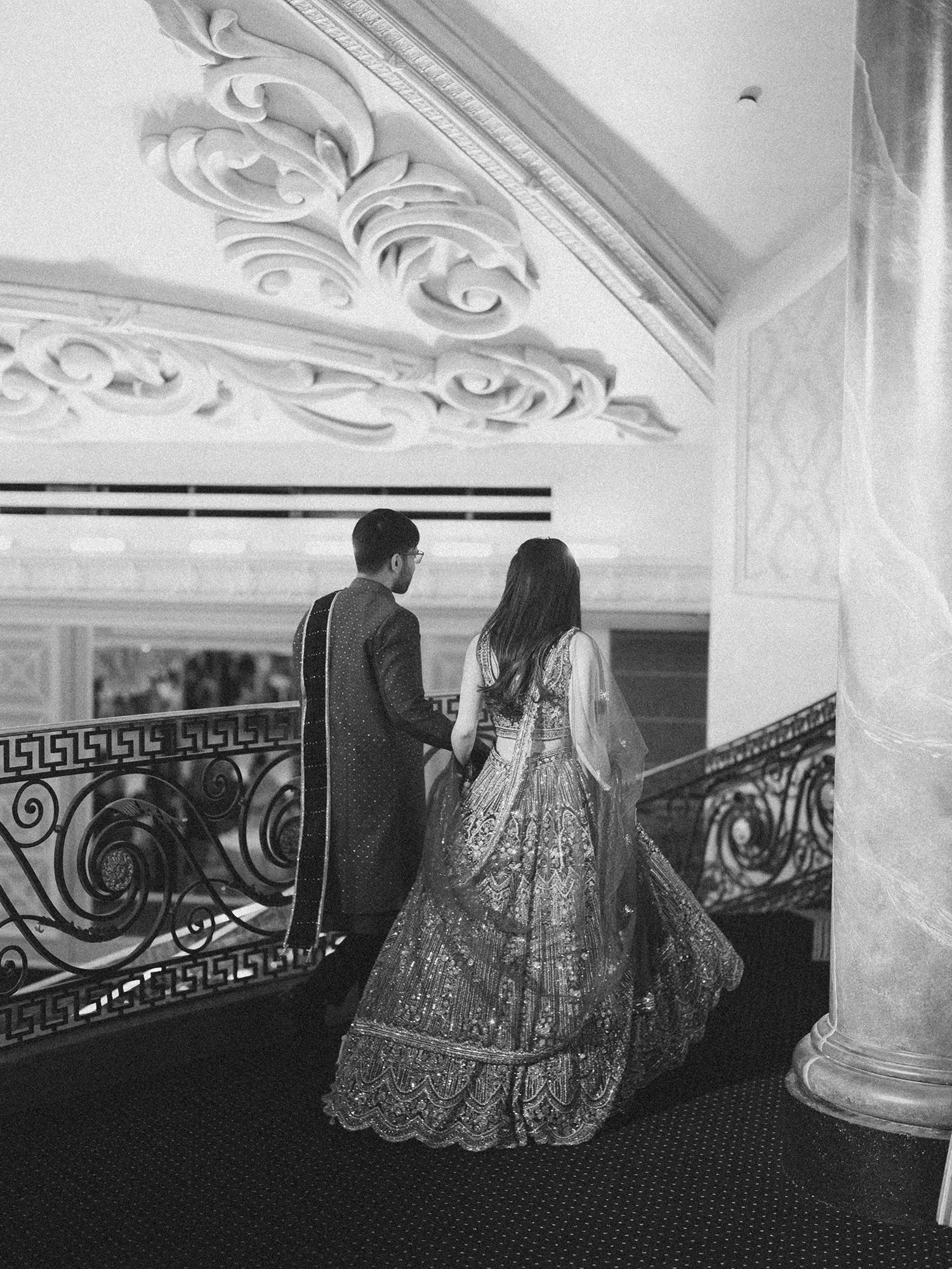  A grand and vibrant wedding portrait of Jenny and Shay sharing a joyful moment inside the luxurious ballroom of The Venetian in New Jersey. 