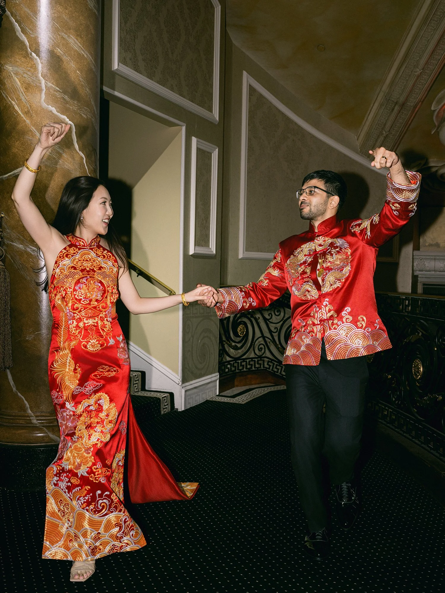  A grand and vibrant wedding portrait of Jenny and Shay sharing a joyful moment inside the luxurious ballroom of The Venetian in New Jersey. 