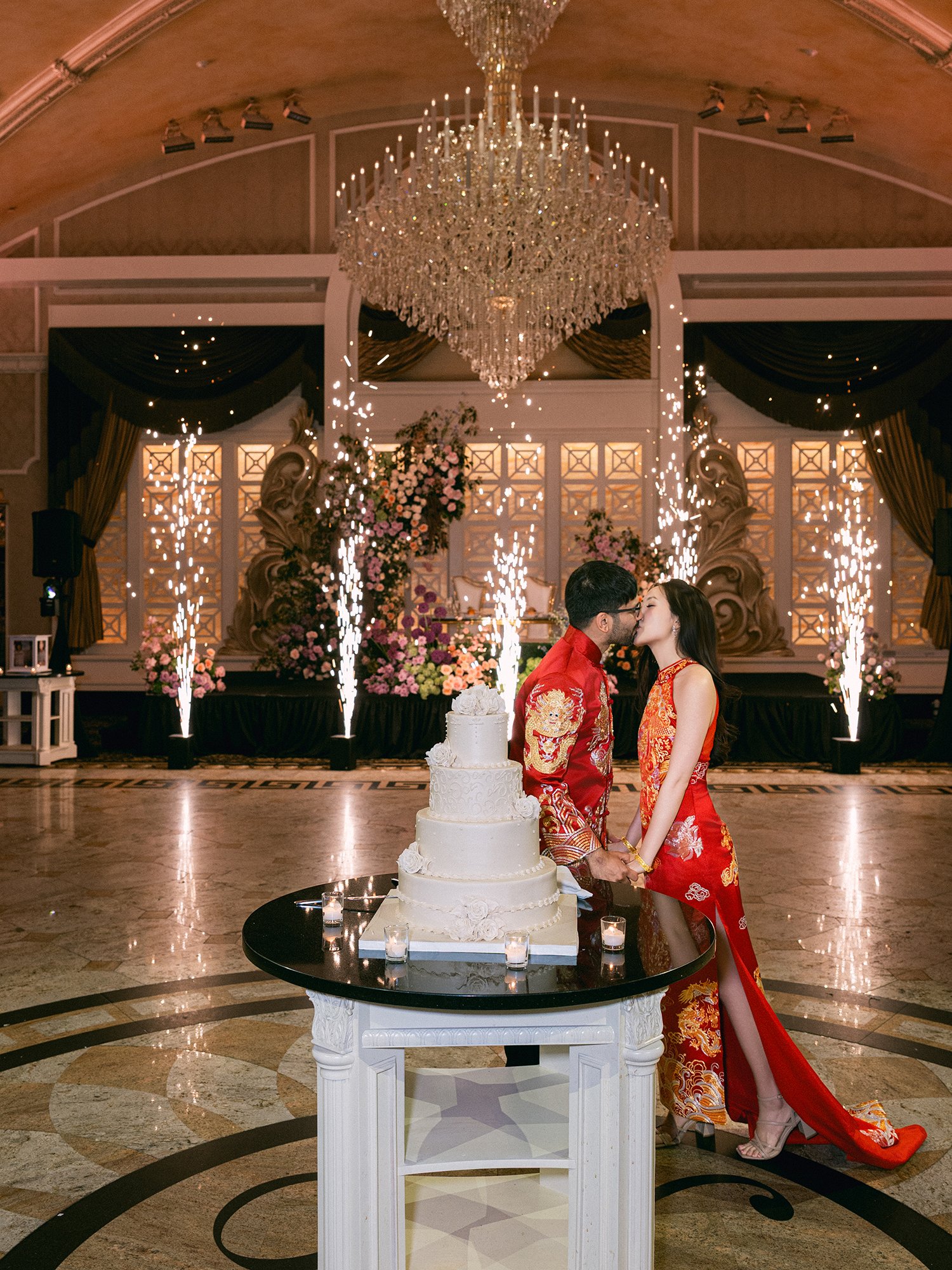  A grand and vibrant wedding portrait of Jenny and Shay sharing a joyful moment inside the luxurious ballroom of The Venetian in New Jersey. 