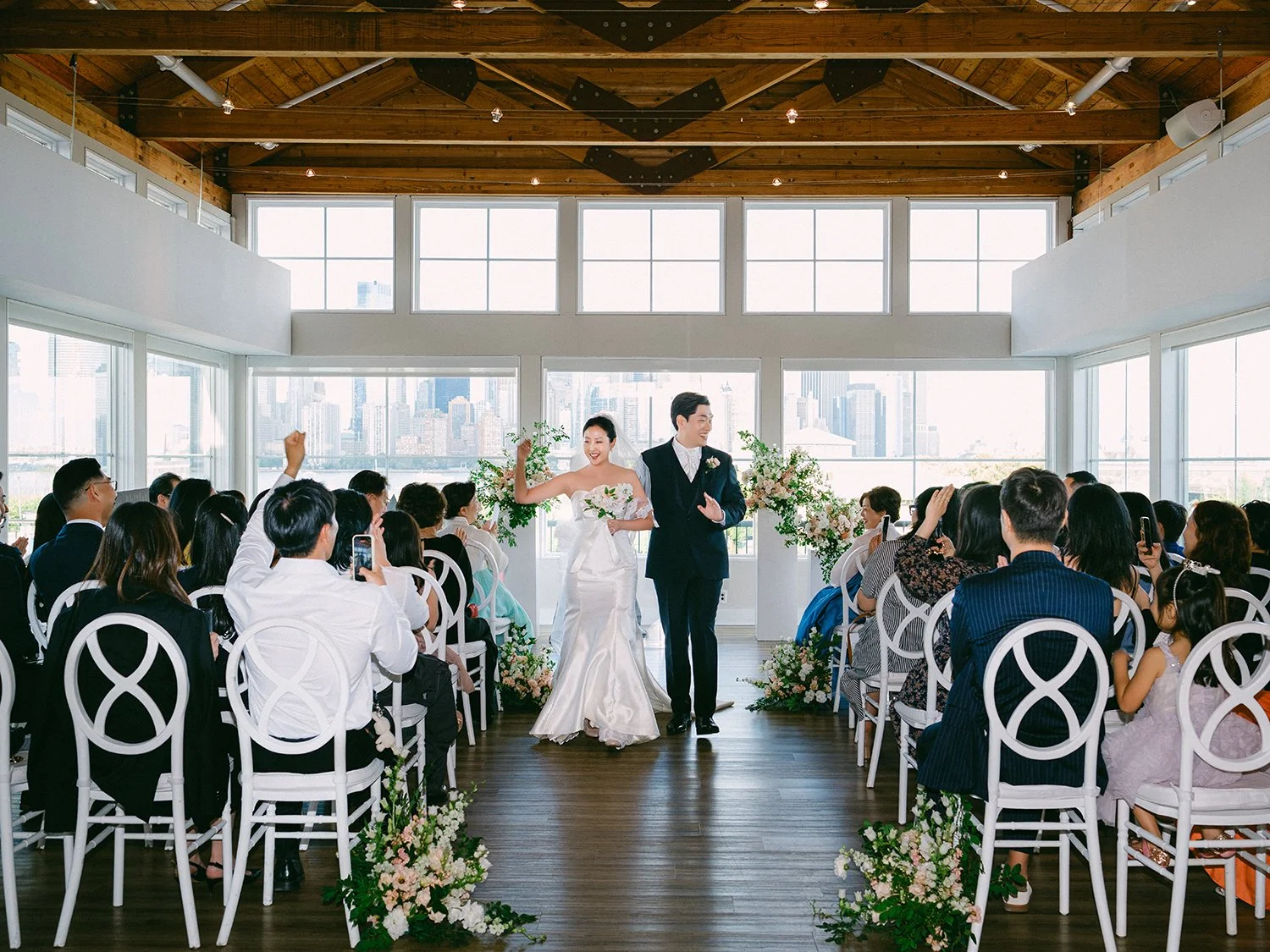 Wedding portrait of Jennifer and Andy at Maritime Parc NJ with the sunny Manhattan skyline in the background by Haseok Chung Studio.