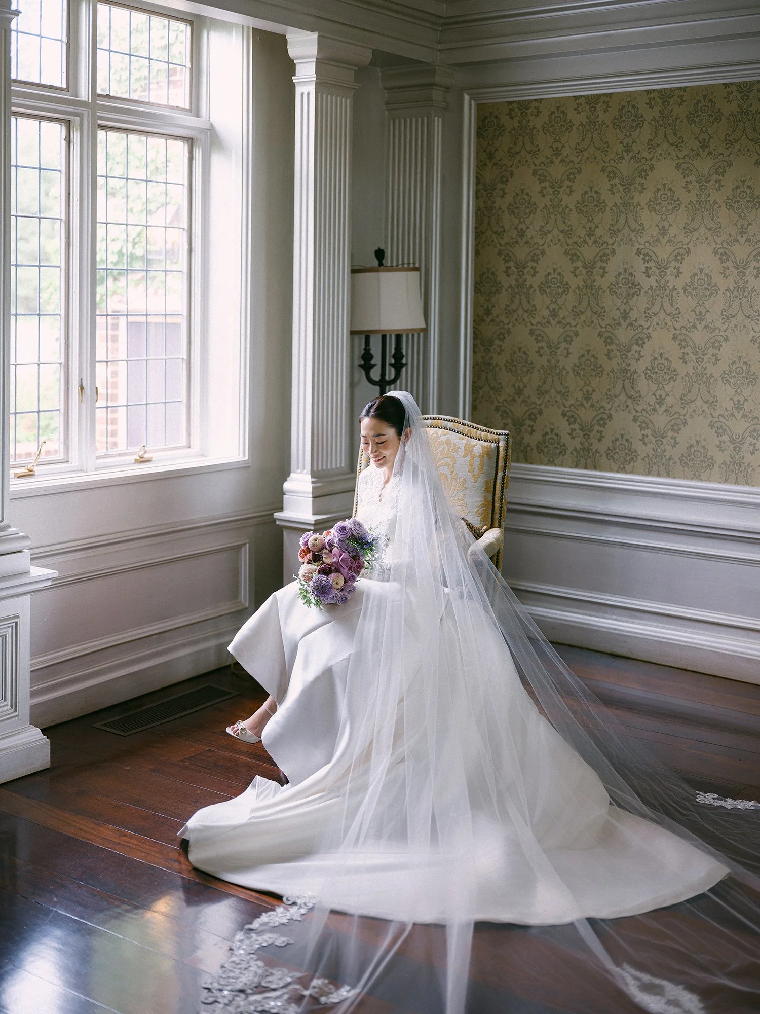 Wedding portrait of Amanda and Michael smiling in front of the historic mansion at Hamilton Farm Golf Club by Haseok Chung Studio.