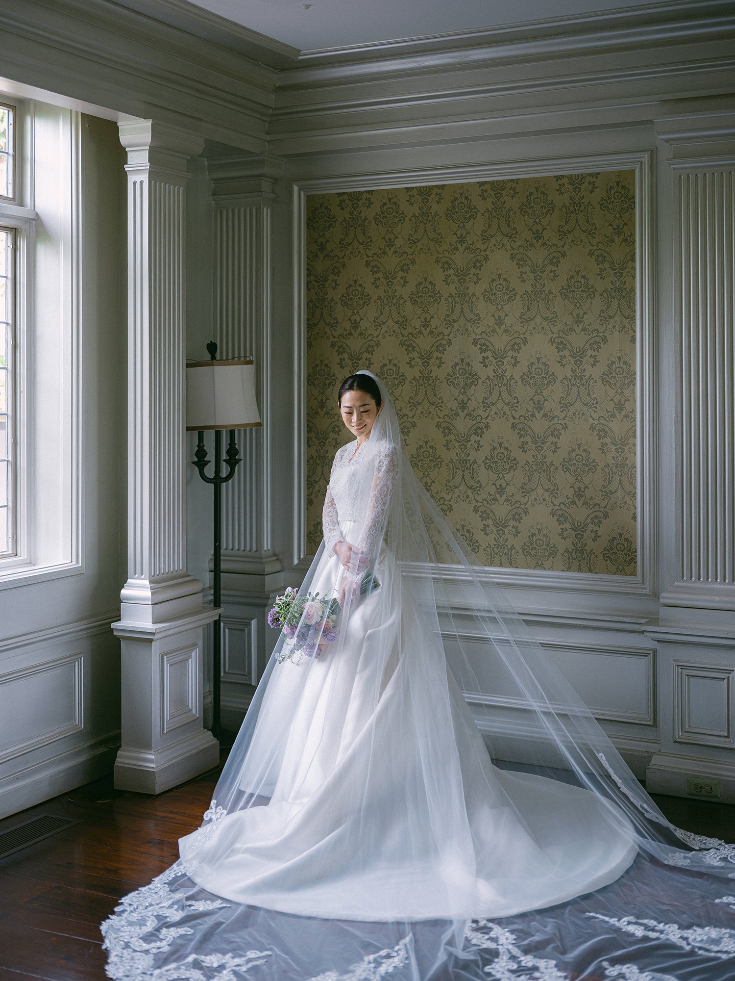 Wedding portrait of Amanda and Michael smiling in front of the historic mansion at Hamilton Farm Golf Club by Haseok Chung Studio.