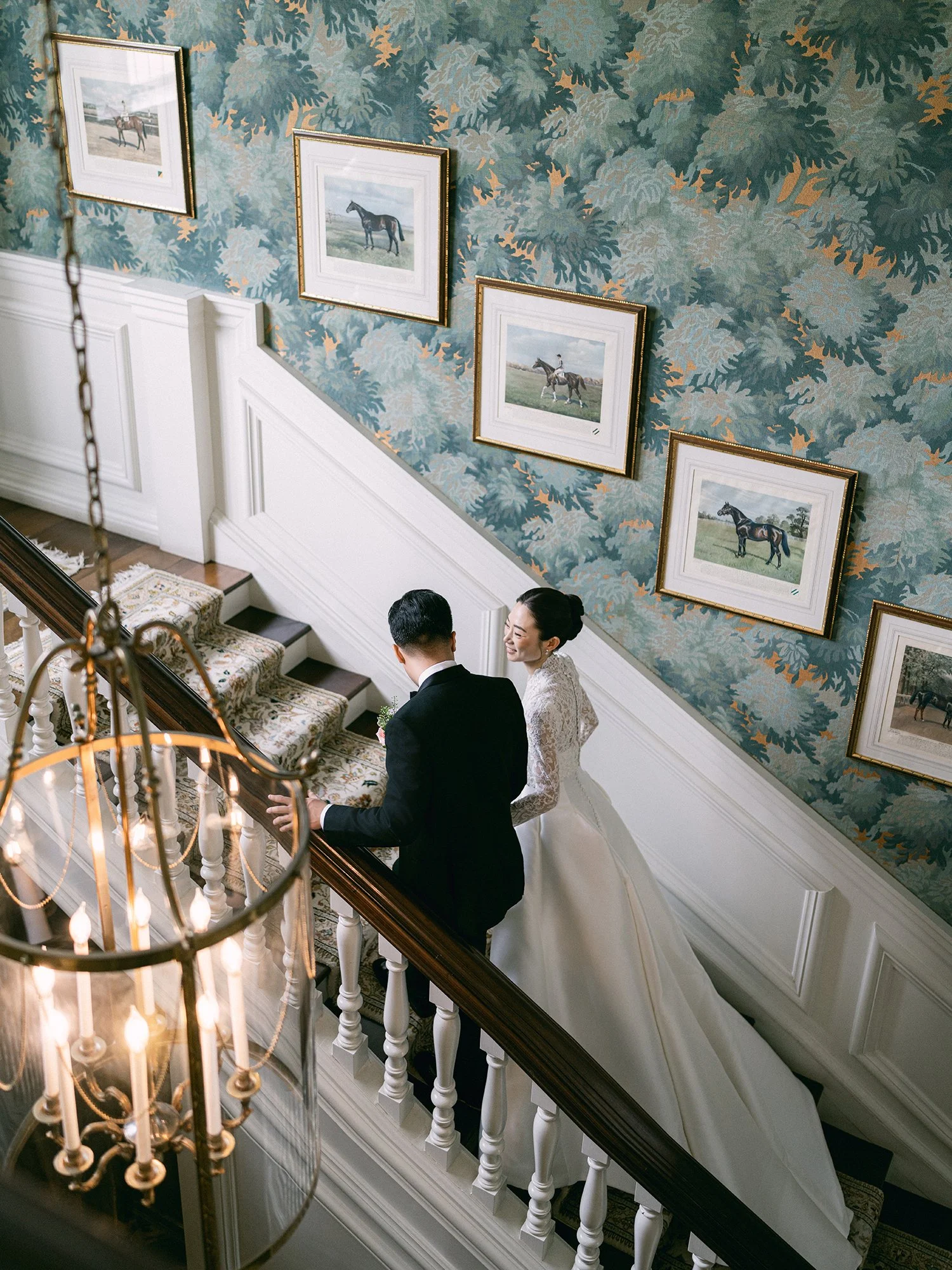 Wedding portrait of Amanda and Michael smiling in front of the historic mansion at Hamilton Farm Golf Club by Haseok Chung Studio.