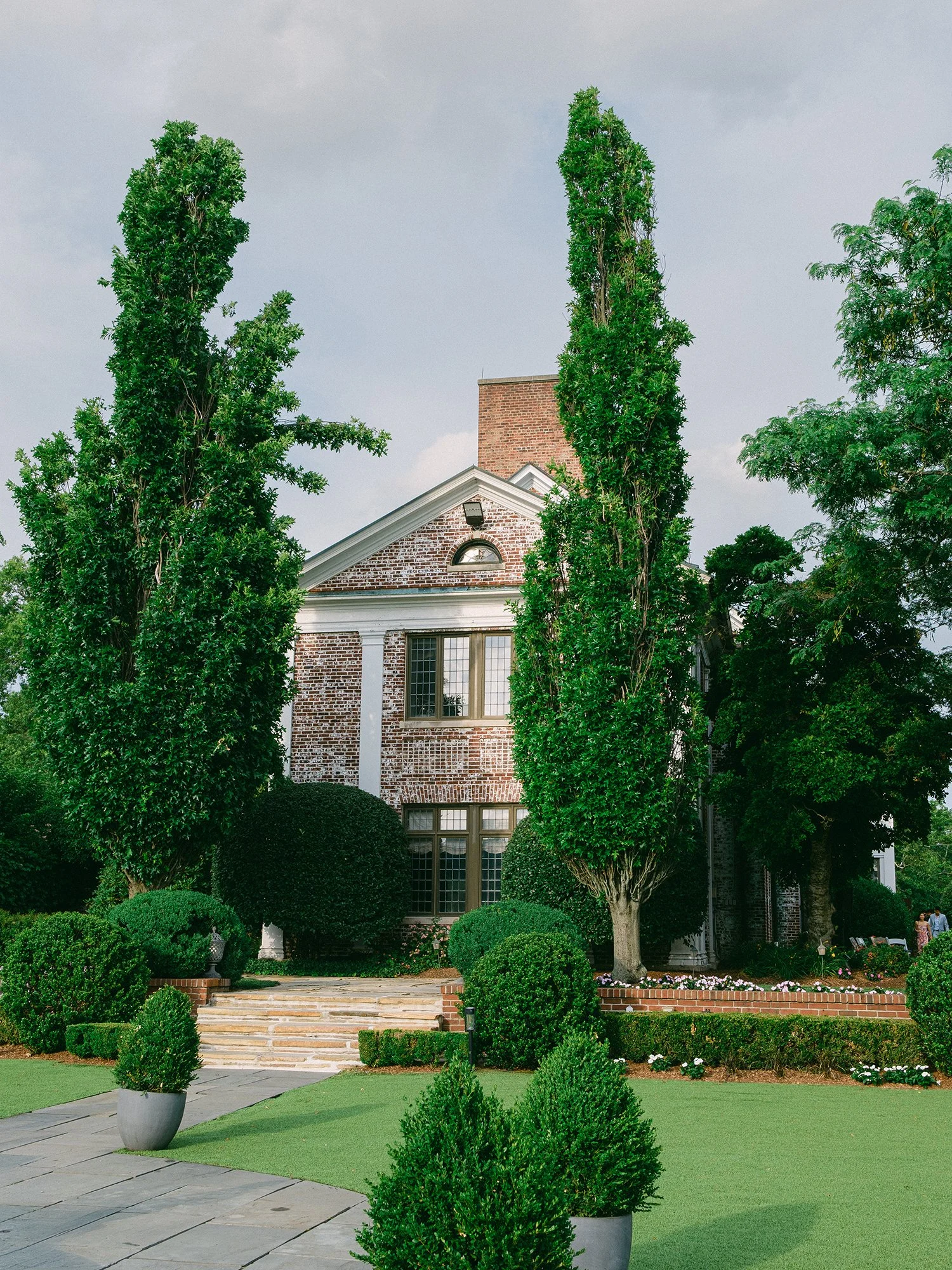 Stunning natural landscape and historic estate architecture of Hamilton Farm Golf Club wedding venue on a bright summer day.