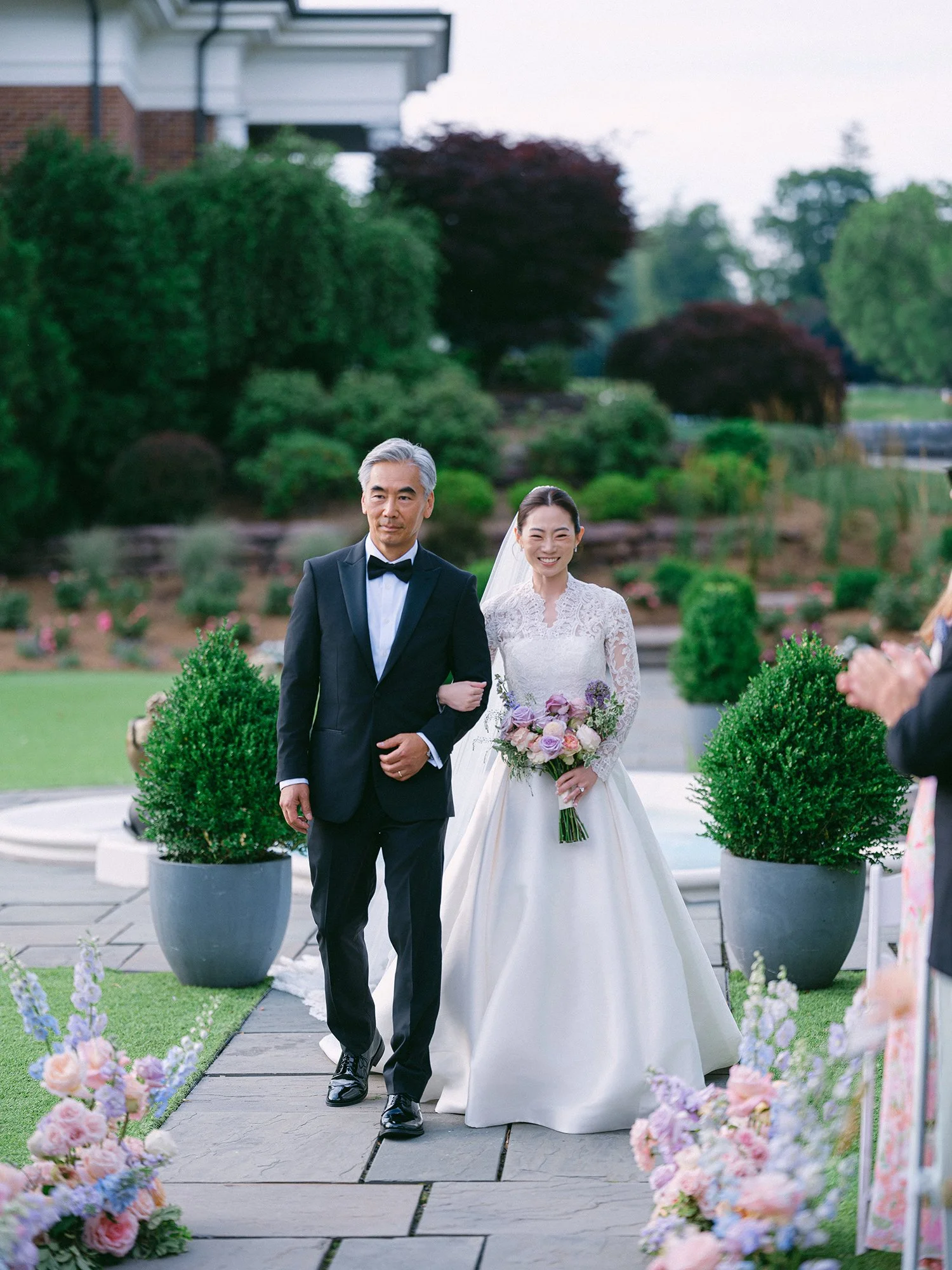 Outdoor summer wedding ceremony at Hamilton Farm featuring lush green surroundings and sophisticated estate details.