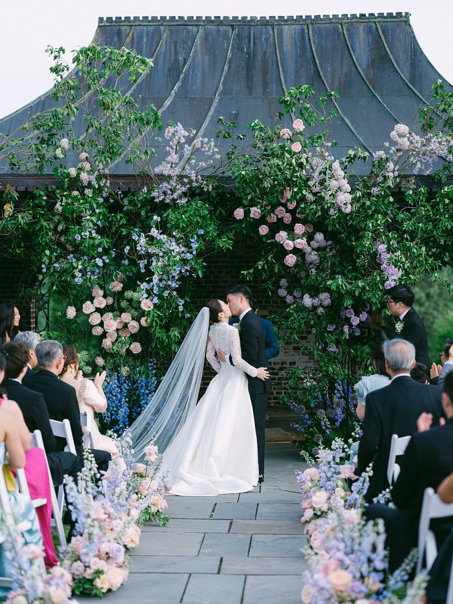 Outdoor summer wedding ceremony at Hamilton Farm featuring lush green surroundings and sophisticated estate details.