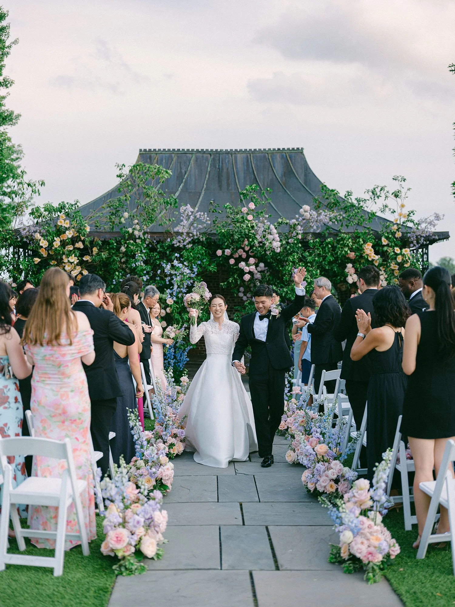 Outdoor summer wedding ceremony at Hamilton Farm featuring lush green surroundings and sophisticated estate details.