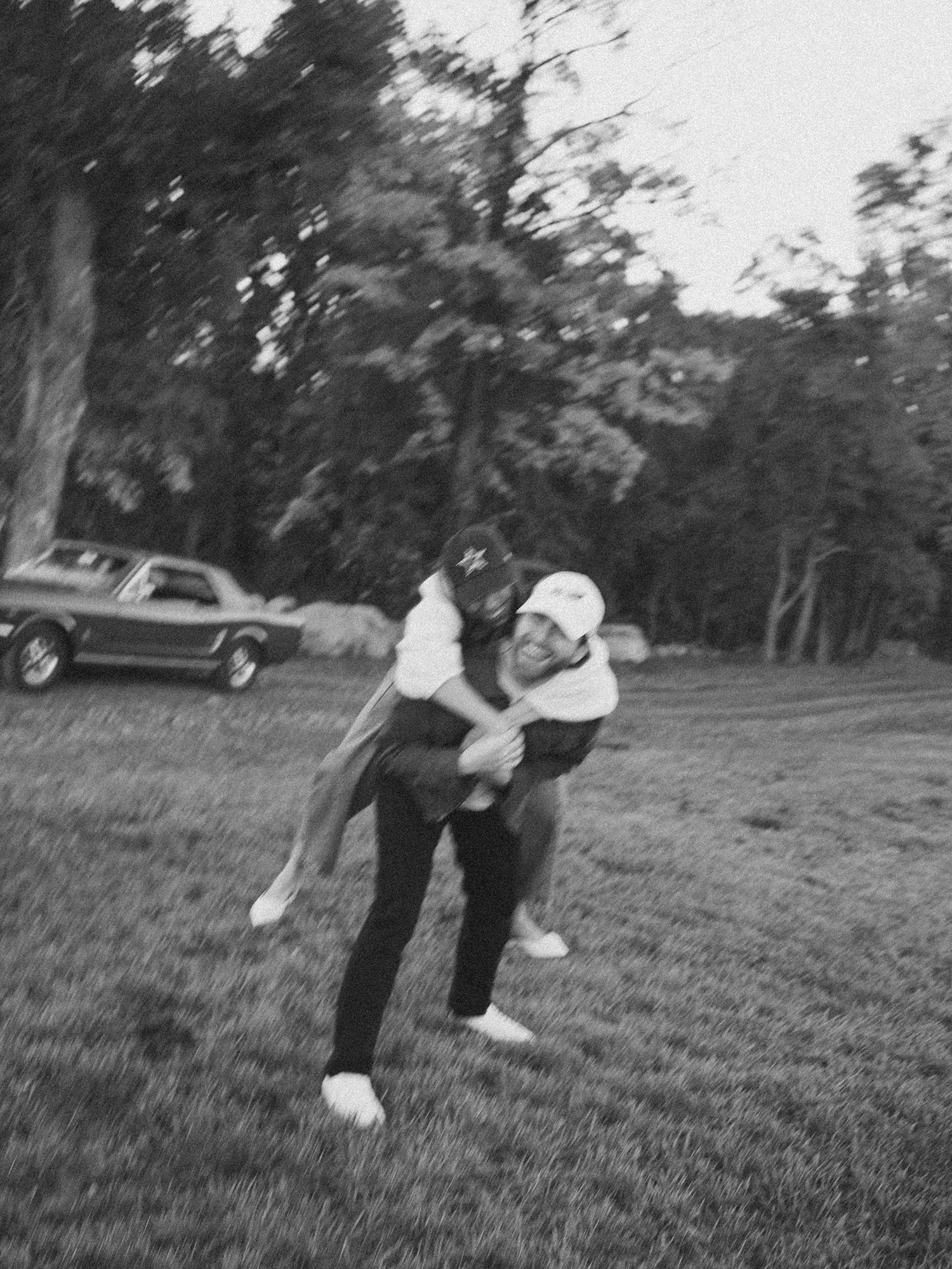The couple with a red 1960s Ford Mustang at their engagement session in Milton, New York
