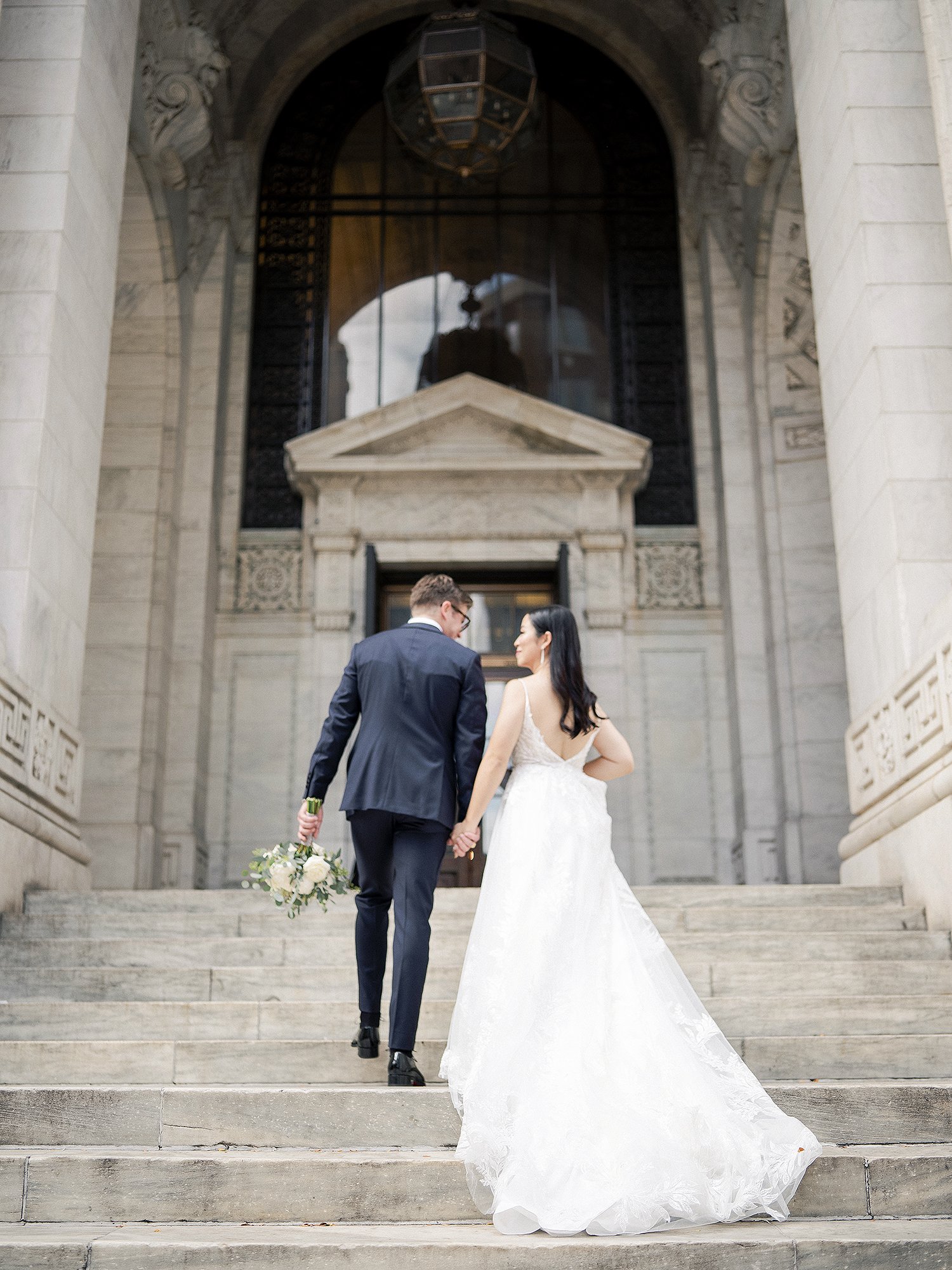 Bride and groom on the steps of a New York City landmark