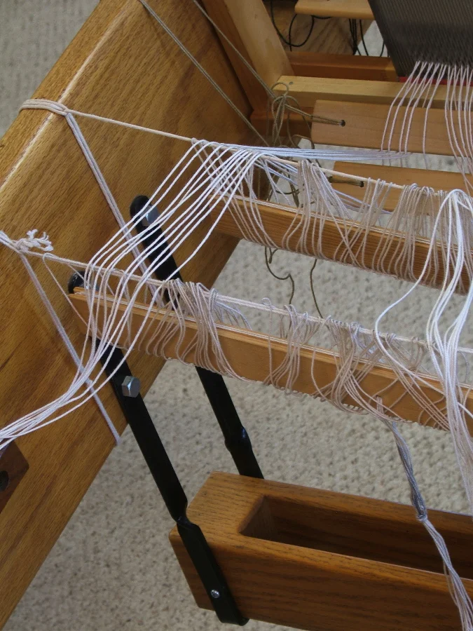 Threading the heddle bars.
©2015