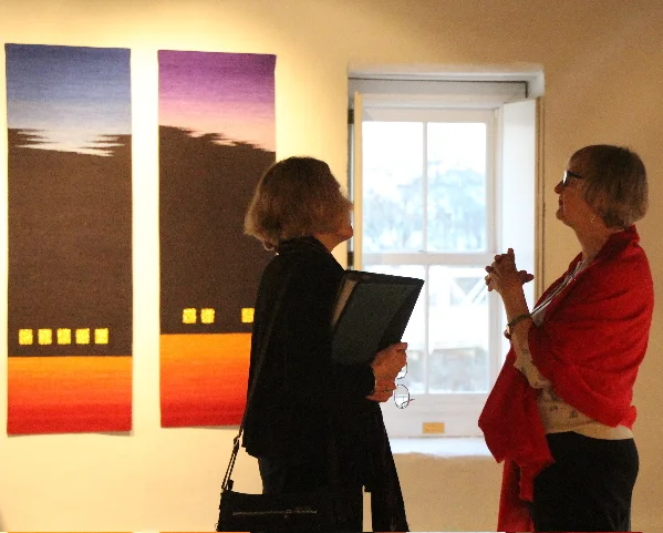 Carol K. Russell and Linda Wallace conversing in front of Rebecca Bluestone’s Landscape Series: Triptych #2 . Photo credit: Lisa Heilman Lomauro
