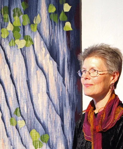 Elizabeth Buckley with her tapestry, Dialogues Through the Veil. Photo credit: Lisa Heilman Lomauro