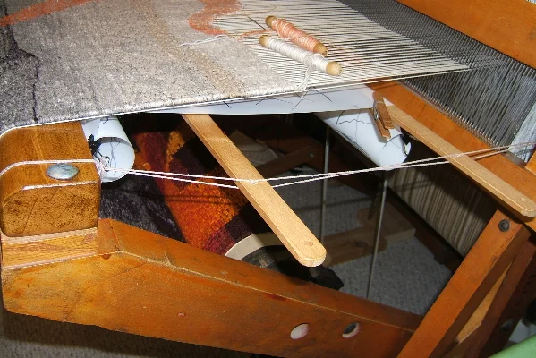 Cartoon support with lease sticks on counter balance rug loom. Note how the cartoon is rolled near the front beam, as well as near the beater. © 2017 Elizabeth J. Buckley photo