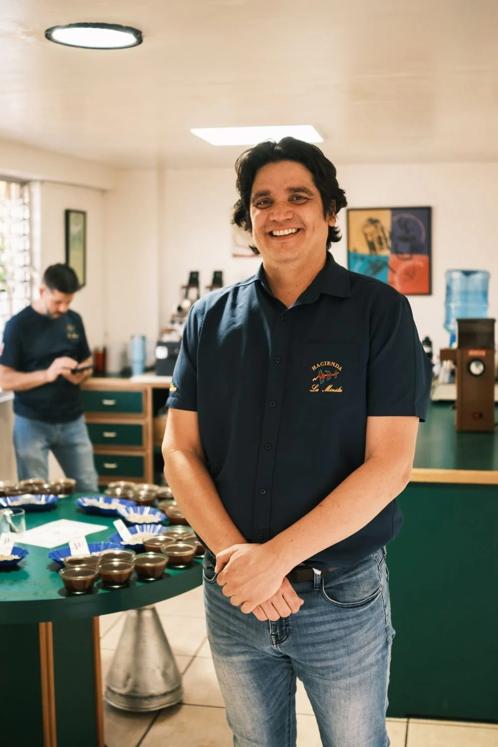 A La Minita team member smiling in the cupping lab