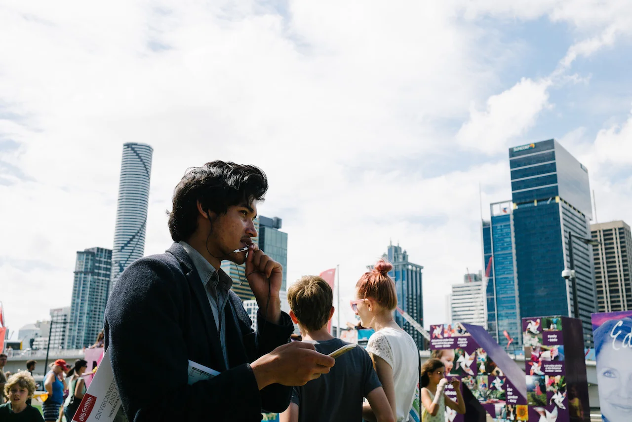 Nick-Bedford-Photographer-Student-talking-on-microphone-South-Bank-Brisbane-Street-Photography.jpg