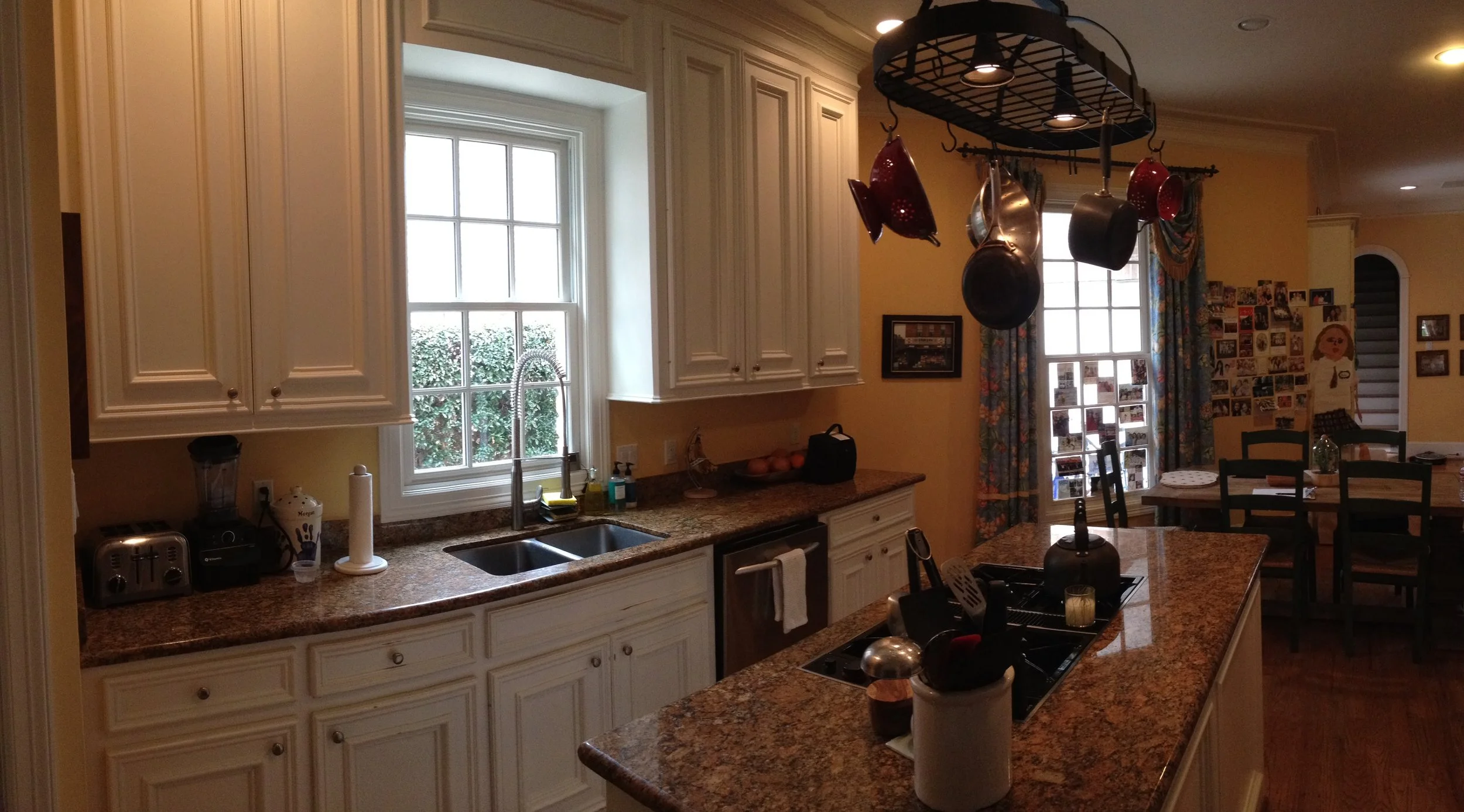  The old kitchen with the cooktop in the island and the sink facing a single window. 