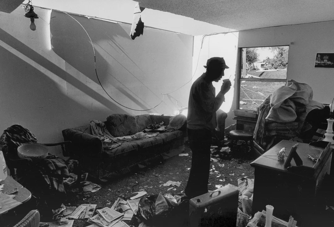 A resident of Petersburg, Ind., was asleep on his couch when a tornado ripped part of the roof off. He calmly sips a cup of coffee the morning after the storm. Seven people were killed when the tornado came through the middle of town.