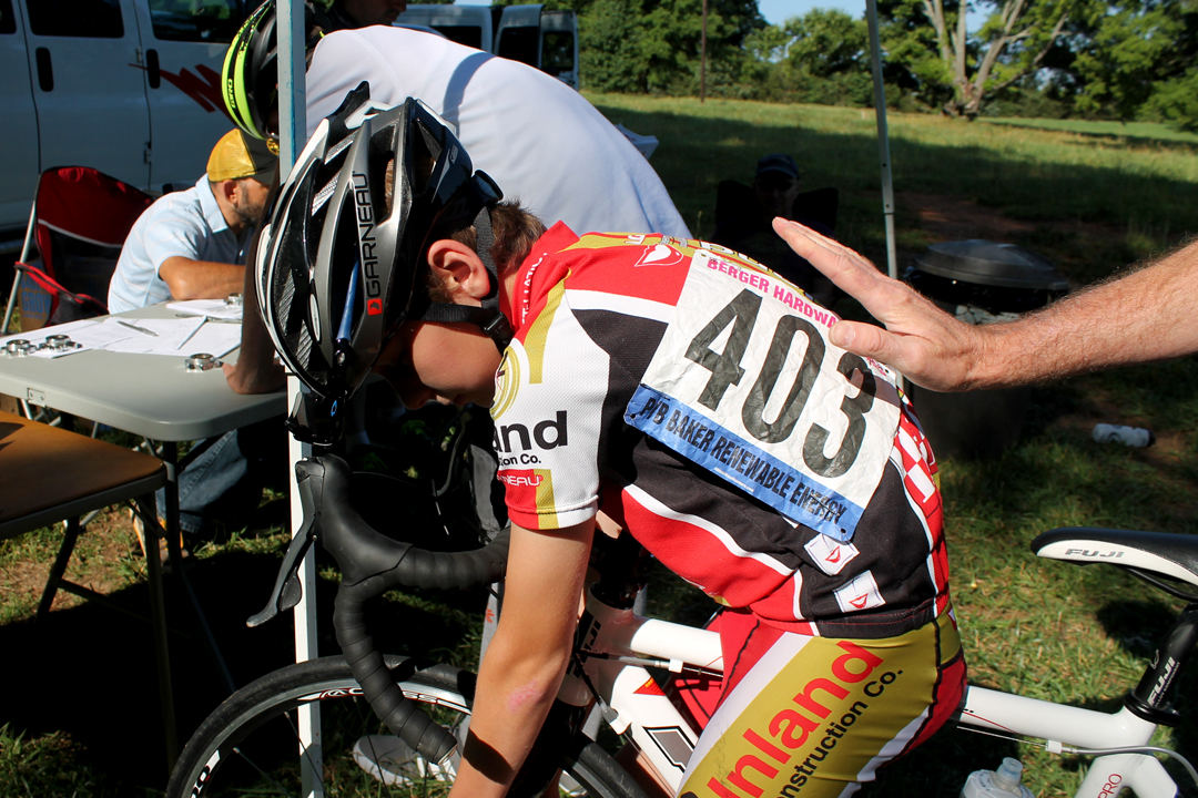 Charlton Stainback, 12, is given the all clear by his father, Richard, after his number is pinned. Charlton attends Creative Studies, a school in Durham that has a cycling team.
