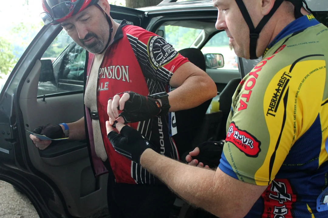 Noel Nunkovich, left, and Chris Crandall pin on their numbers. Avid racers, they frequently participate in a time trial series at the Charlotte Motor Speedway. One weekend they raced in three events, including a mountain bike time trial at Lake Crab…