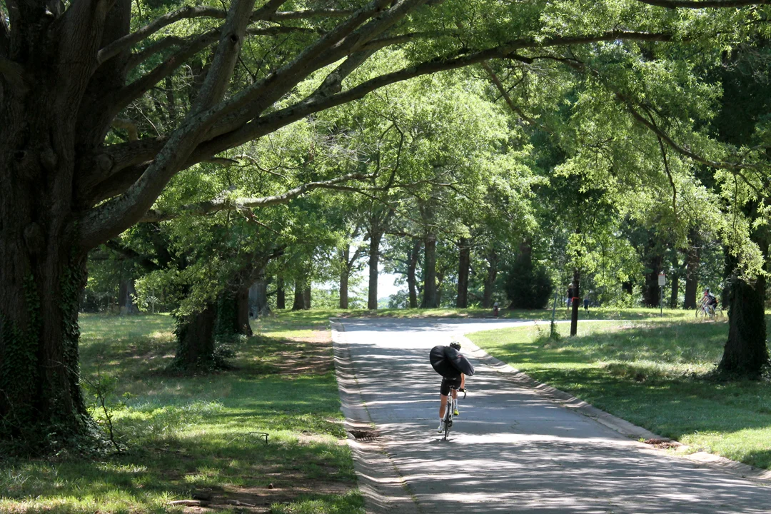 A rider carries his wheel bags at day's end.