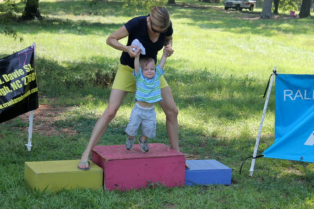 Beth Hancock plays with her son, Colby. Beth and her husband, Todd, will be racing cyclocross for the Oak City Cycling Project Race Team.