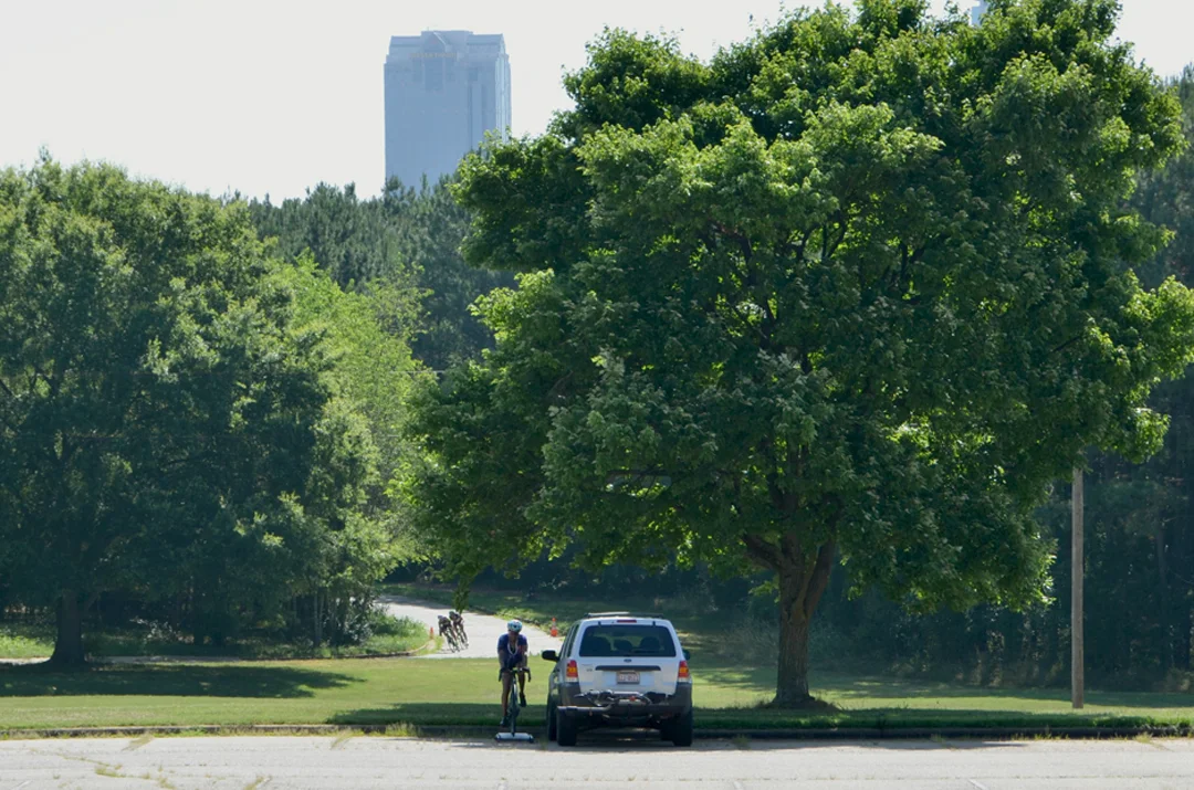 Tanya Harris of Raleigh rides her rollers in a shady spot while another category races. Harris is a Cat. 4 and just started racing; this day was her sixth criterium. The Spring Hill campus grounds are close to downtown Raleigh.