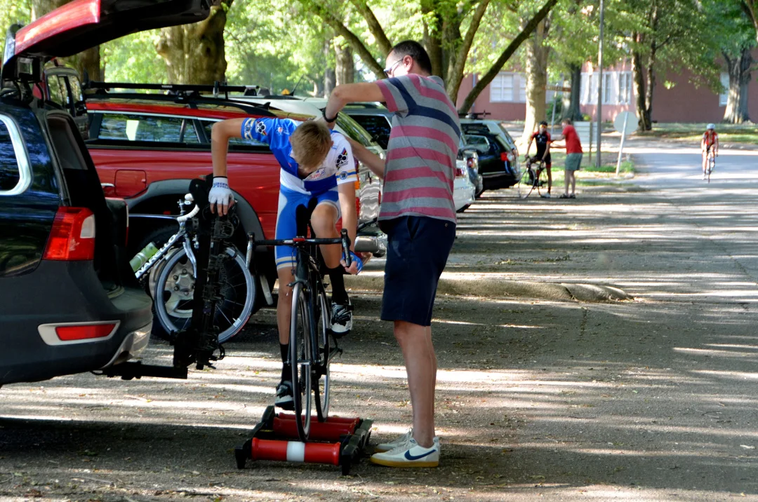 Hugo Schreur, 15, warms up while his father, Jan, helps with his number. Hugo races as a Cat. 4 and participated in a three-week, July racing camp in Belgium. The Schreur's live in Chapel Hill.
