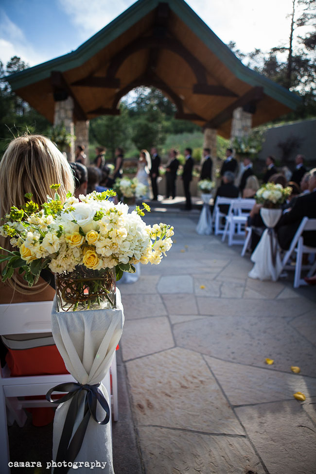 ceremony aisle with creamy yellow flowers.jpg
