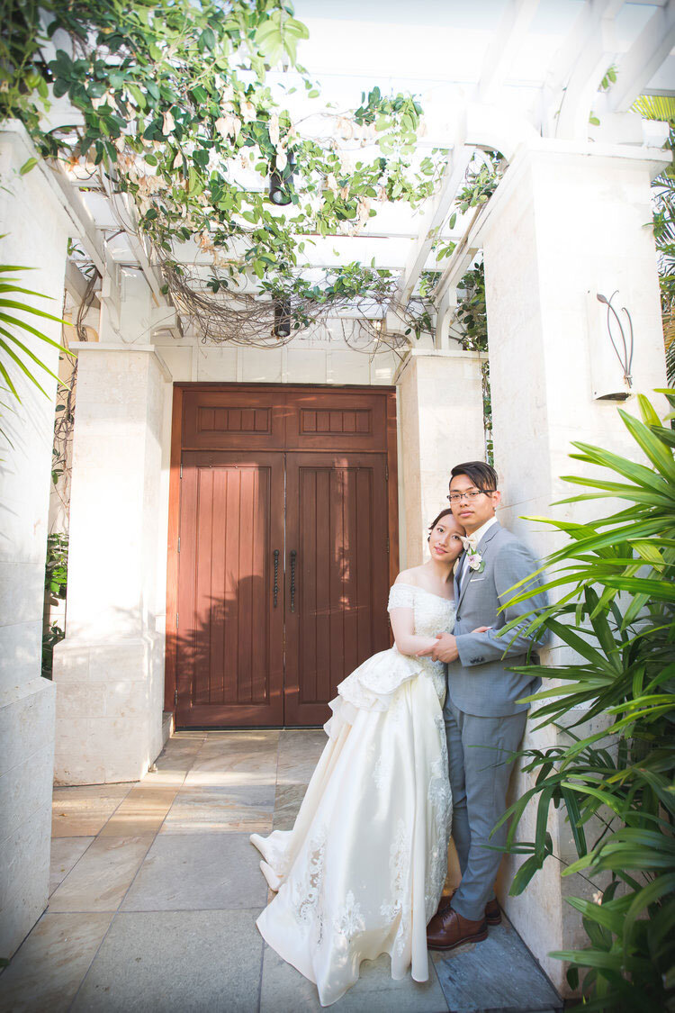 bride-and-groom-inside-hallway-white-beach-chapel-waikiki.jpg