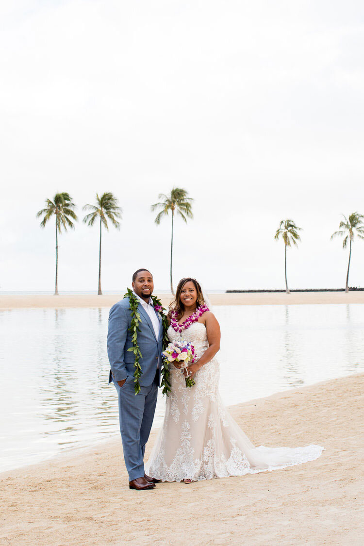 bride-and-groom-next-to-lagoon-at-hilton-hawaiian-village.jpg