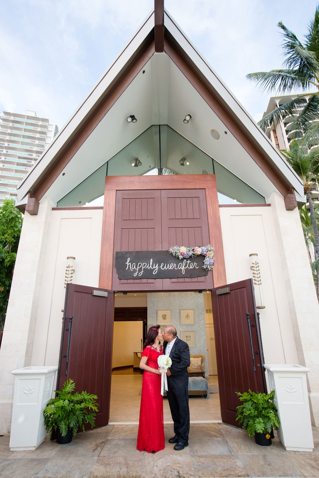 bride-and-groom-kissing-outside-white-beach-chapel.jpg